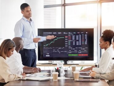 Business people, stock market dashboard on screen and coach for trading, finance presentation and g