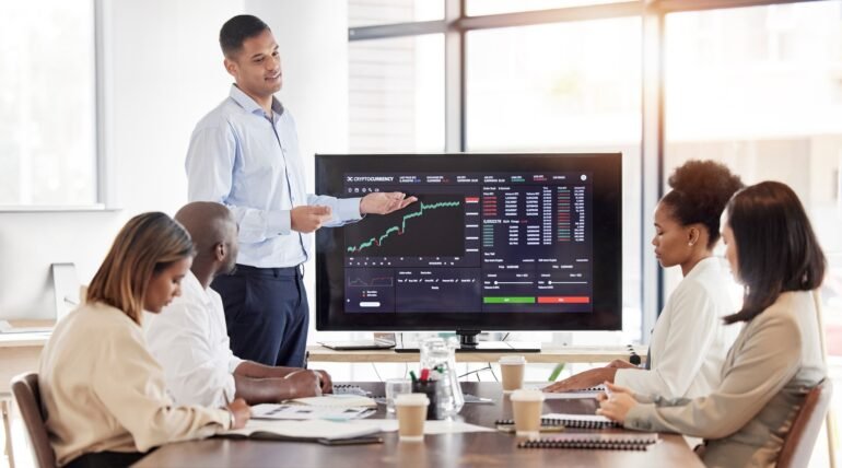 Business people, stock market dashboard on screen and coach for trading, finance presentation and g